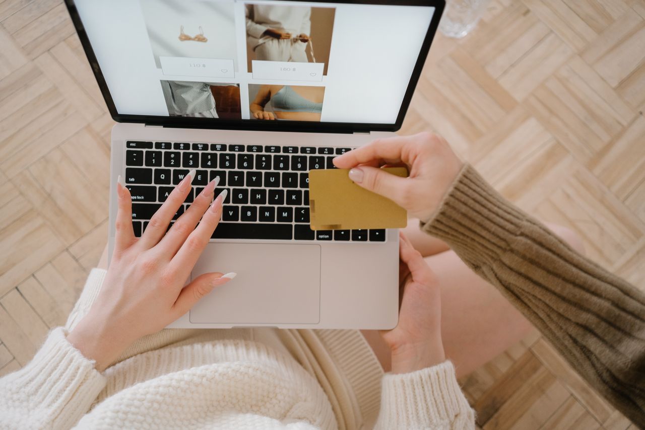 Home Person shopping online using a laptop and credit card, highlighting e-commerce convenience.